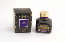 Load image into Gallery viewer, A glass bottle of 80ml Diamine Scribble Purple fountain pen ink next to its packaging box, in front of a white background.
