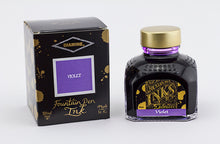 Load image into Gallery viewer, A glass bottle of 80ml Diamine Violet fountain pen ink next to its packaging box, in front of a white background.
