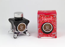 Load image into Gallery viewer, A glass bottle of 50ml Diamine Red Edition Inkvent Winter Spice Shimmer fountain pen ink next to packaging box, in front of a white background.
