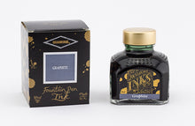 Load image into Gallery viewer, A glass bottle of 80ml Diamine Graphite fountain pen ink next to its packaging box, in front of a white background.
