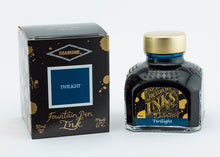Load image into Gallery viewer, A glass bottle of 80ml Diamine Twilight fountain pen ink next to its packaging box, in front of a white background.
