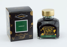Load image into Gallery viewer, A glass bottle of 80ml Diamine Emerald fountain pen ink next to its packaging box, in front of a white background.
