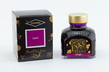 Load image into Gallery viewer, A glass bottle of 80ml Diamine Grape fountain pen ink next to its packaging box, in front of a white background.
