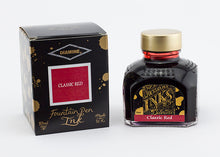 Load image into Gallery viewer, A glass bottle of 80ml Diamine Classic Red fountain pen ink next to its packaging box, in front of a white background.
