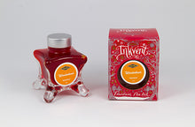 Load image into Gallery viewer, A glass bottle of 50ml Diamine Red Edition Inkvent Wonderland fountain pen ink next to packaging box, in front of a white background.
