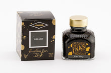 Load image into Gallery viewer, A glass bottle of 80ml Diamine Earl Grey fountain pen ink next to its packaging box, in front of a white background.
