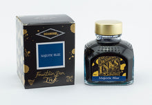 Load image into Gallery viewer, A glass bottle of 80ml Diamine Majestic Blue fountain pen ink next to its packaging box, in front of a white background.
