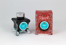 Load image into Gallery viewer, A glass bottle of 50ml Diamine Red Edition Inkvent Subzero Shimmer fountain pen ink next to packaging box, in front of a white background.
