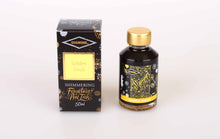 Load image into Gallery viewer, A glass bottle of 50ml Diamine Golden Sands shimmering fountain pen ink next to its packaging box, in front of a white background.
