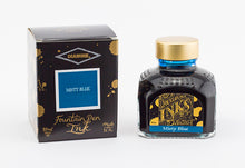 Load image into Gallery viewer, A glass bottle of 80ml Diamine Misty Blue fountain pen ink next to its packaging box, in front of a white background.
