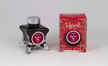 Load image into Gallery viewer, A glass bottle of 50ml Diamine Red Edition Inkvent Raspberry Rose fountain pen ink next to packaging box, in front of a white background.
