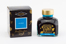 Load image into Gallery viewer, A glass bottle of 80ml Diamine Asa Blue fountain pen ink next to its packaging box, in front of a white background.

