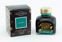 Load image into Gallery viewer, A glass bottle of 80ml Diamine Cool Green fountain pen ink next to its packaging box, in front of a white background.
