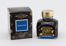 Load image into Gallery viewer, A glass bottle of 80ml Diamine Prussian Blue fountain pen ink next to its packaging box, in front of a white background.
