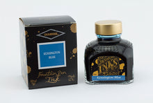 Load image into Gallery viewer, A glass bottle of 80ml Diamine Kensington Blue fountain pen ink next to its packaging box, in front of a white background.
