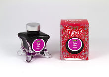 Load image into Gallery viewer, A glass bottle of 50ml Diamine Red Edition Inkvent Party Time Shimmer fountain pen ink next to packaging box, in front of a white background.
