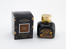 Load image into Gallery viewer, A glass bottle of 80ml Diamine Tobacco Sunburst fountain pen ink next to its packaging box, in front of a white background.
