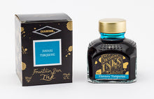 Load image into Gallery viewer, A glass bottle of 80ml Diamine Havasu Turquoise fountain pen ink next to its packaging box, in front of a white background.

