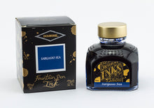 Load image into Gallery viewer, A glass bottle of 80ml Diamine Sargasso Sea fountain pen ink next to its packaging box, in front of a white background.
