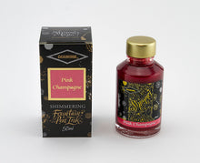 Load image into Gallery viewer, A glass bottle of 50ml Diamine Pink Champagne shimmering fountain pen ink next to its packaging box, in front of a white background.
