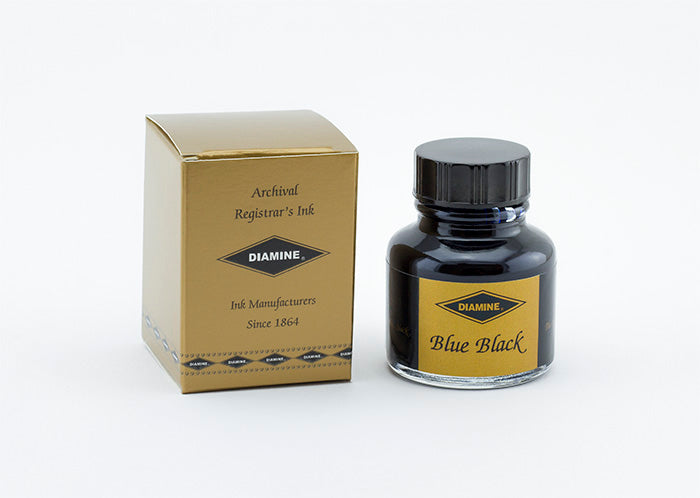 A glass bottle of 30ml Diamine Archival Registrars fountain pen ink next to its packaging box, in front of a white background.