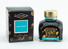 Load image into Gallery viewer, A glass bottle of 80ml Diamine Aqua Lagoon fountain pen ink next to its packaging box, in front of a white background.
