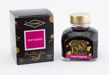 Load image into Gallery viewer, A glass bottle of 80ml Diamine Deep Magenta fountain pen ink next to its packaging box, in front of a white background.
